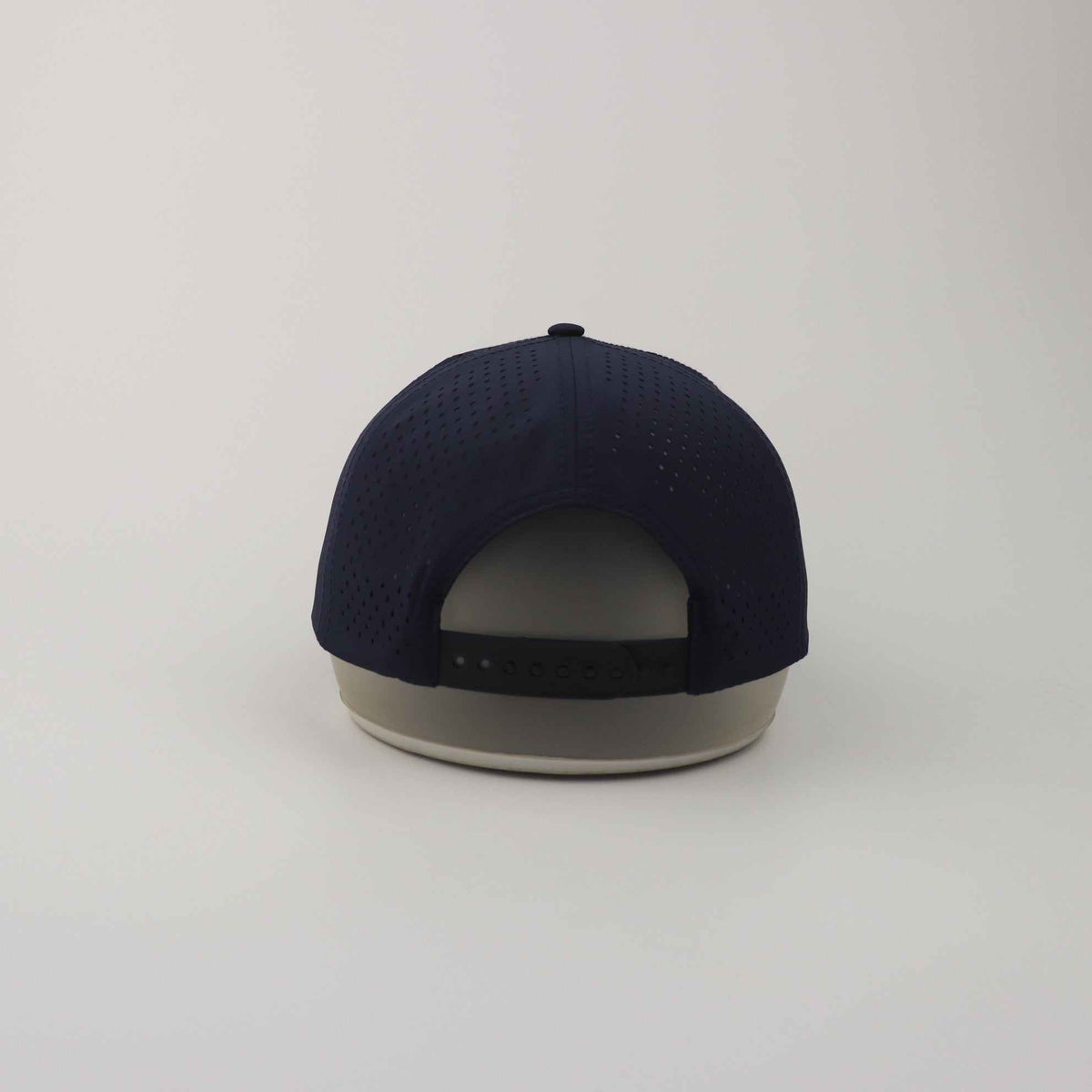 Navy Blue Golf Snapback Hat made of breathable perforated polyester with adjustable plastic snapback closure and structured crown