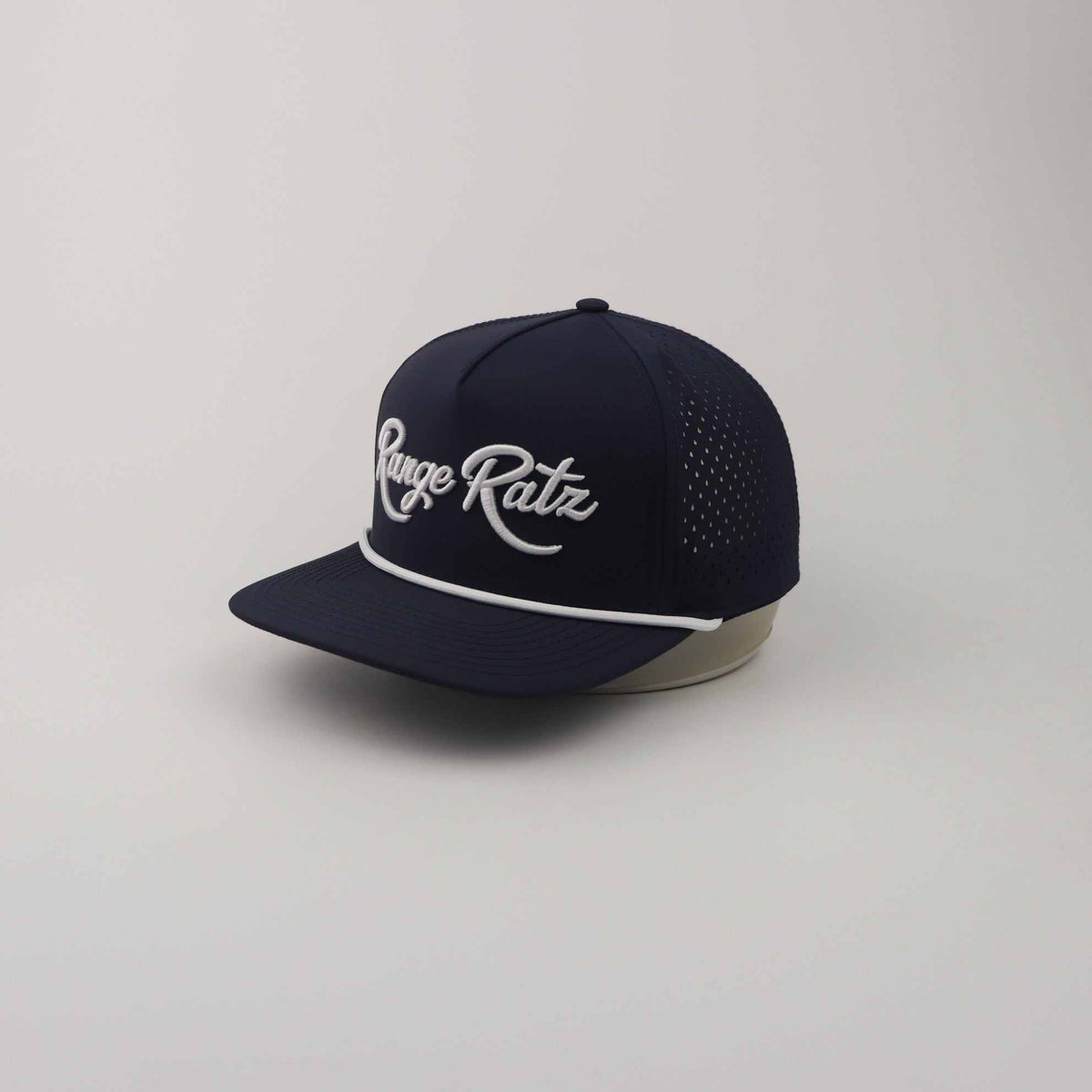 Navy Blue Golf Snapback Hat with white Range Ratz 3D embroidery, perforated polyester panels, and rope detail on curved brim